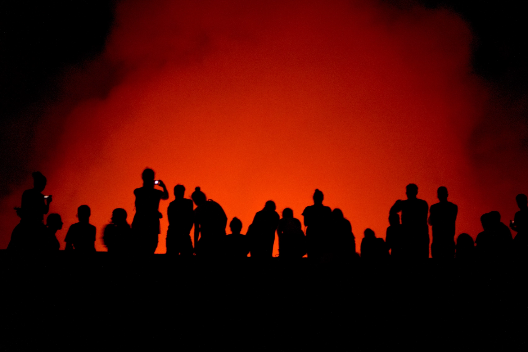 Volcan Masaya, Nicaragua A group of travellers is silhouetted by red lava inside Volcan Masaya in Nicaragua