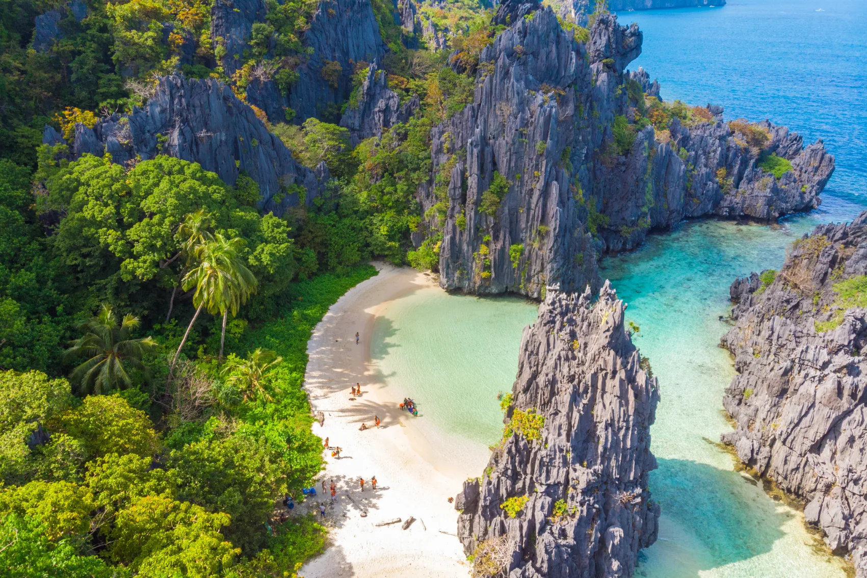 Aerial view of Hidden Beach between two large rock formations in the Philippines