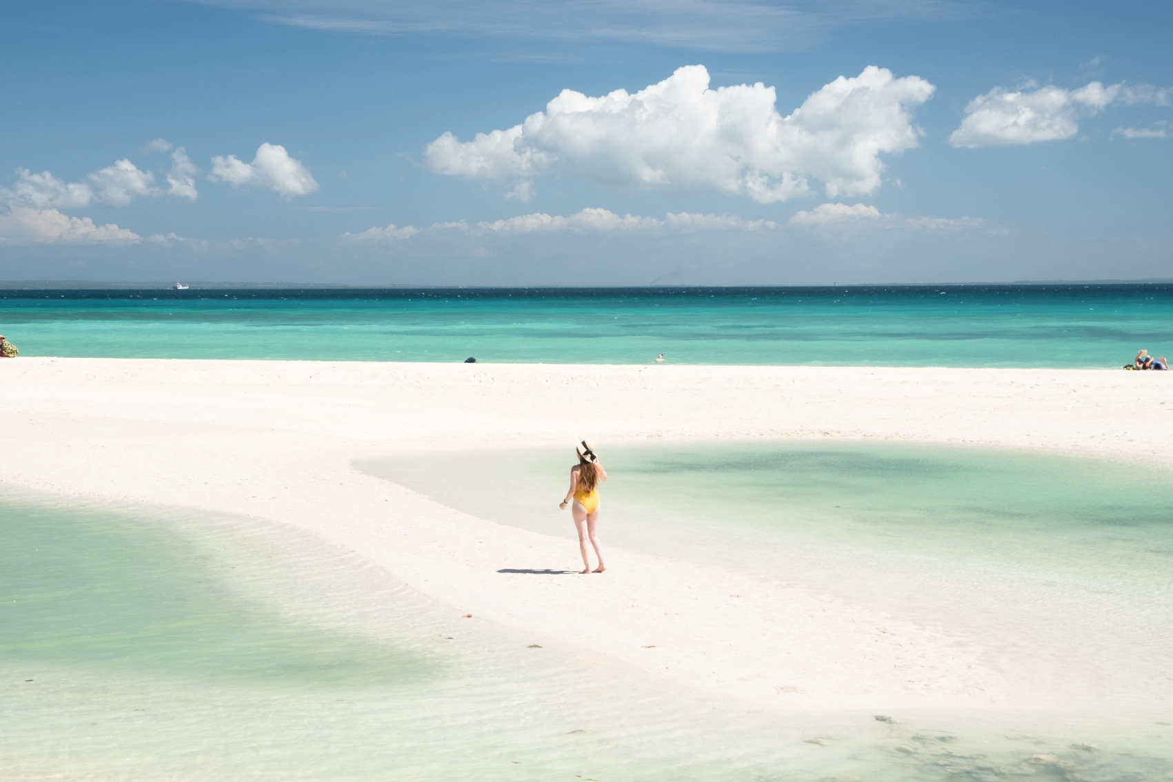 A woman traveller walks along a sand bank on Bantayan Island, Philippines