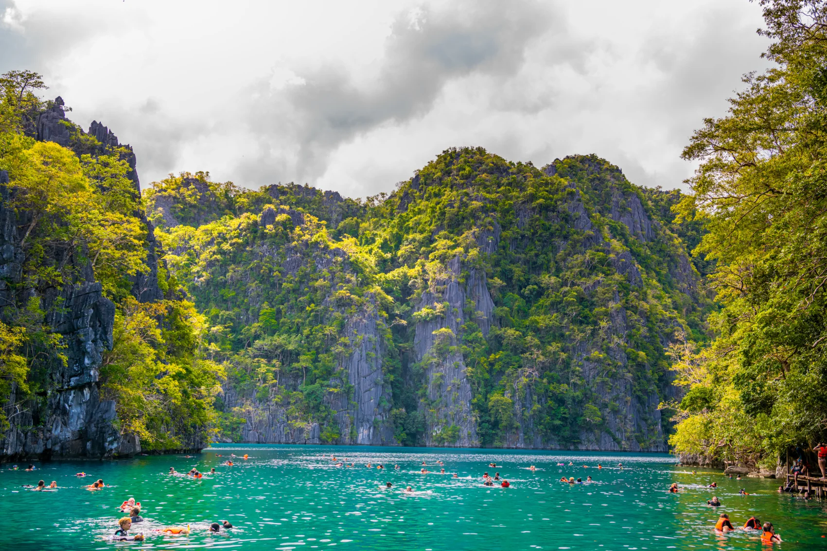 People swim in Kayangan Lake on Coron Island, Philippines