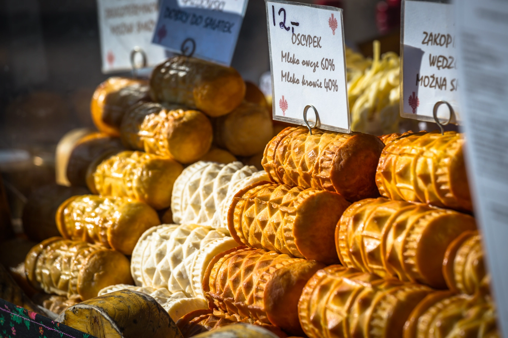 Stacks of oscypek cheese at a market stall in Poland