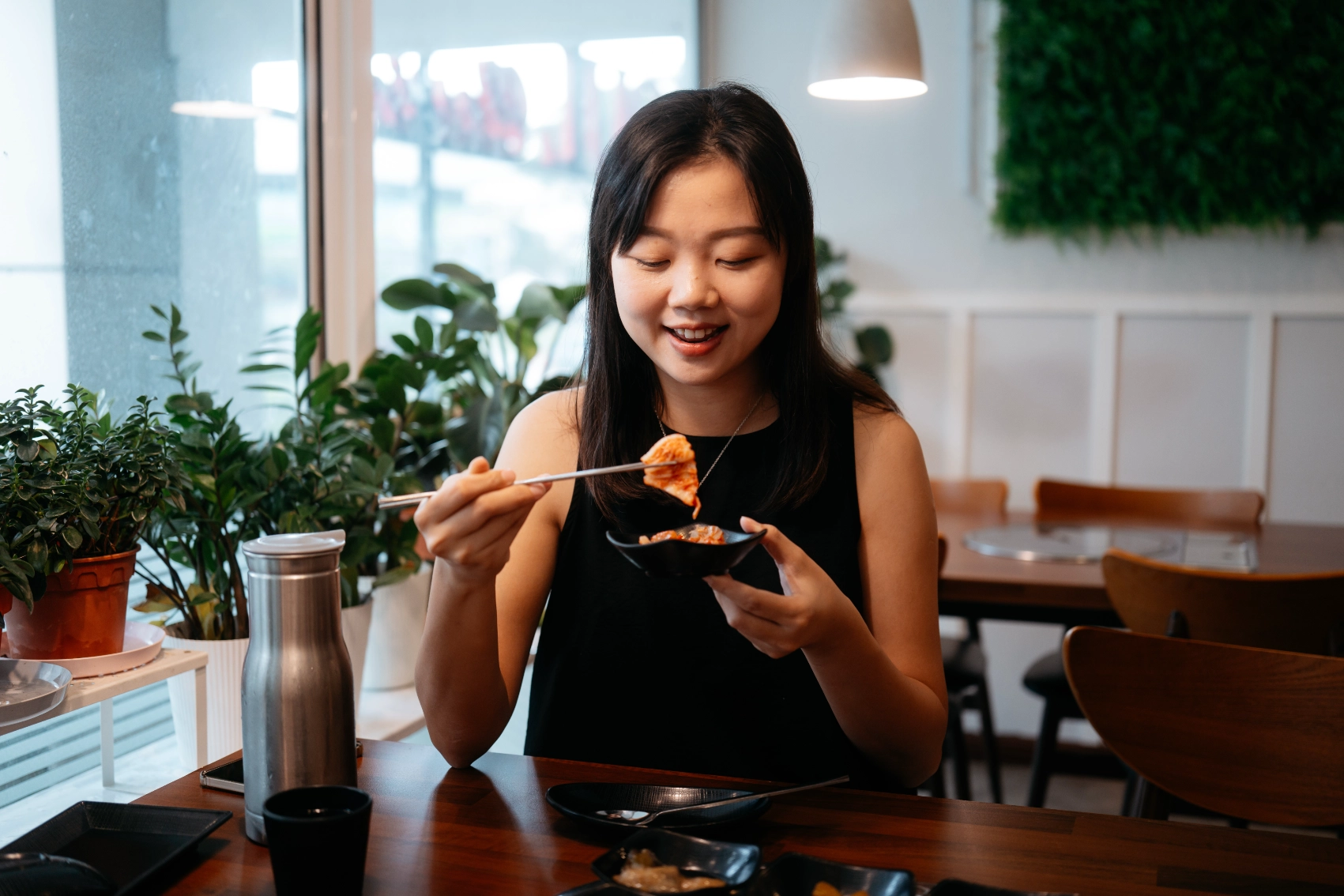 A woman traveller eating kimchi at a restaurant in in South Korea