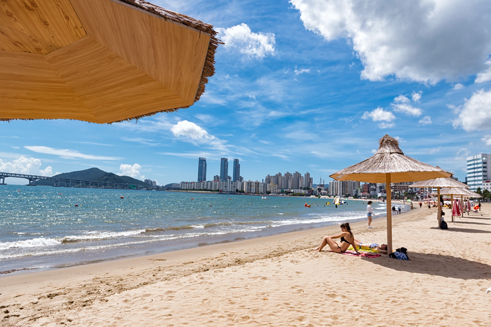 A woman traveller relaxes on Busan Beach in South Korea
