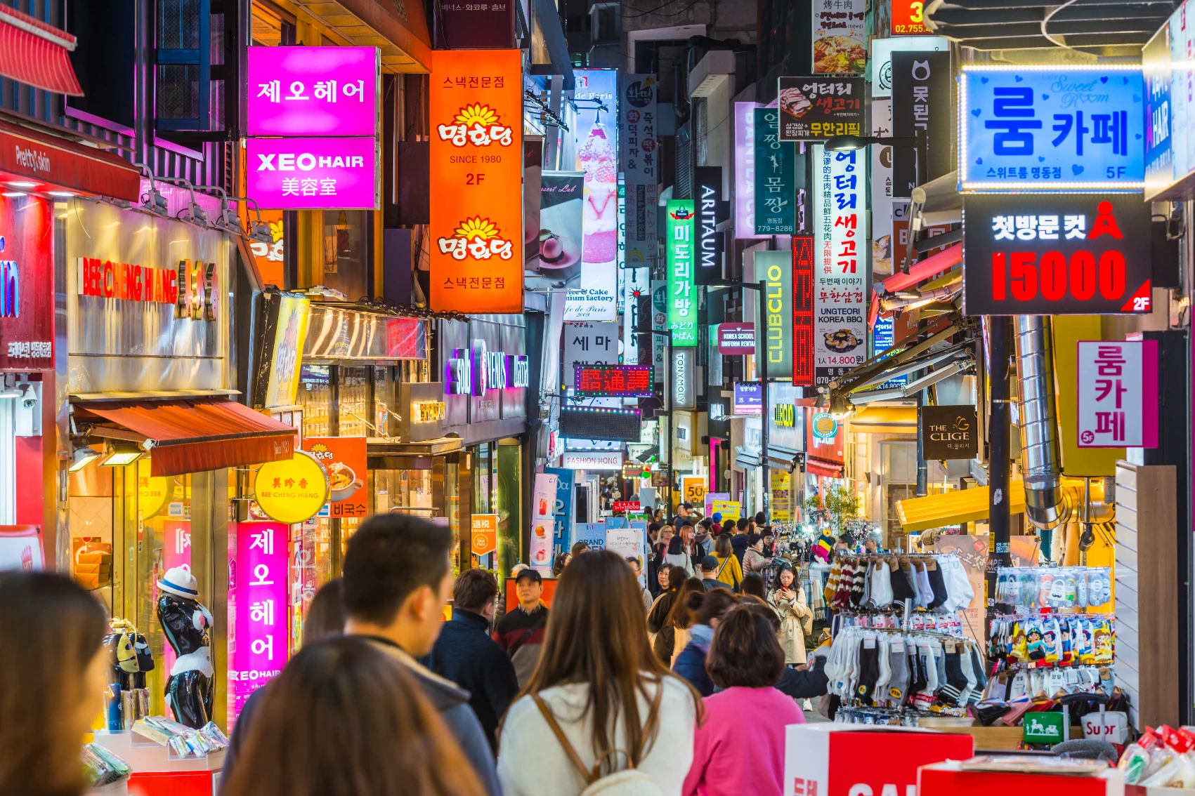Crowds of people walk through Myeongdong, Seoul, at night in South Korea