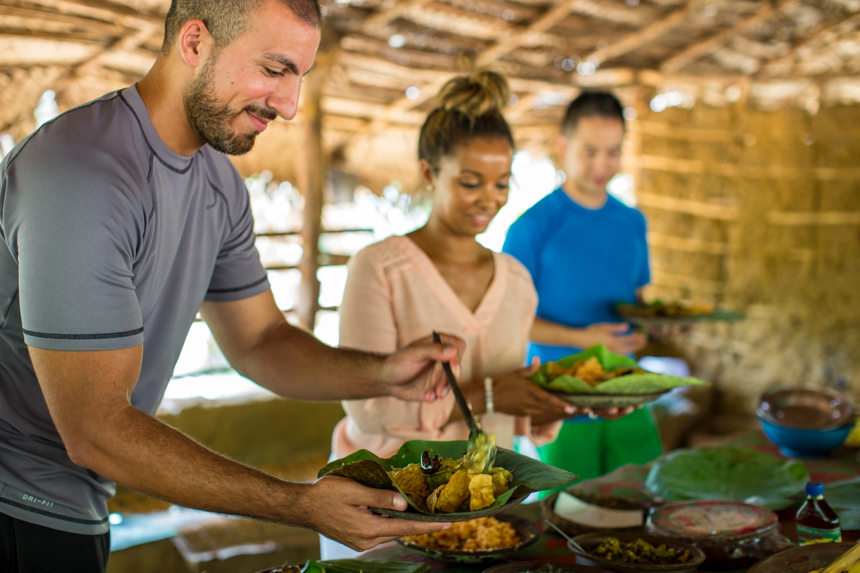 Travellers dish up food after a cooking class in Sri Lanka