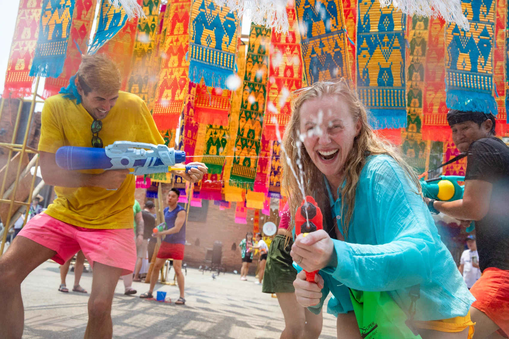 Travellers shoot waterguns during the Songkran festival in Thailand