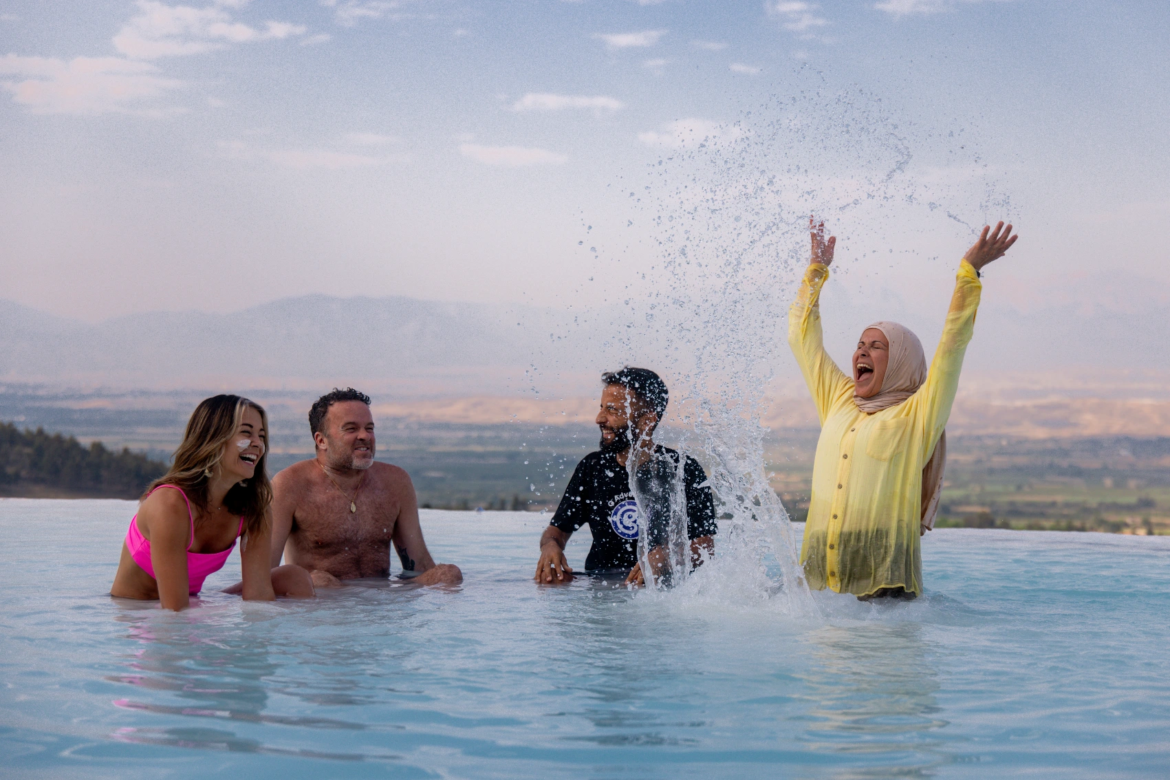 Travellers splash in the natural pools of Pamukkale, Turkey