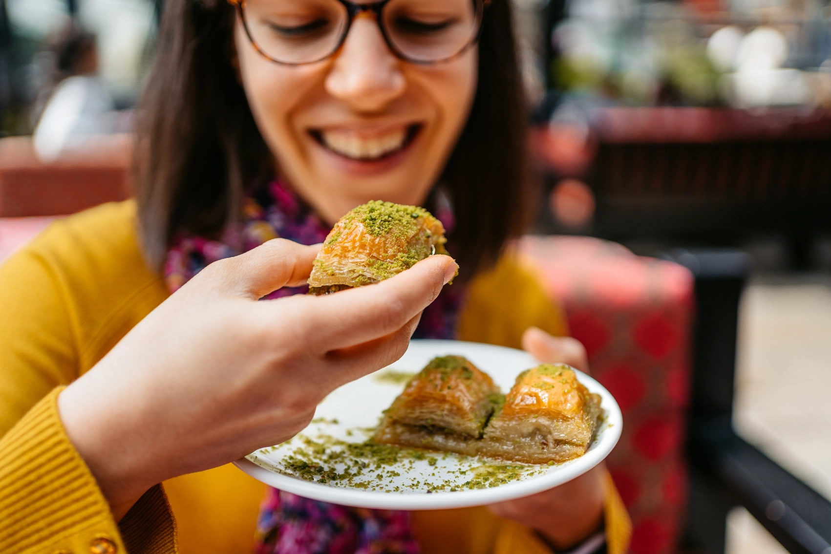 A female traveller eats a piece of baklava in Turkey