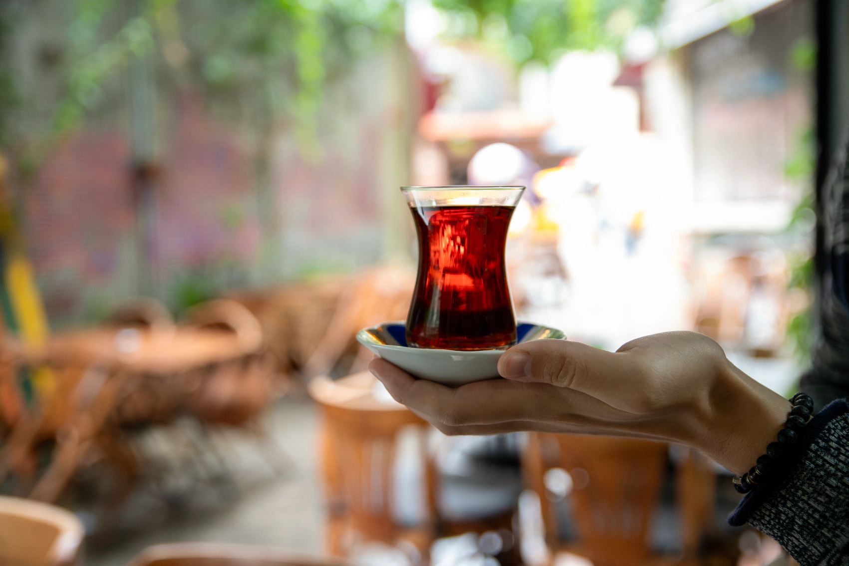 A person holds a cup of tea on the street in Turkey