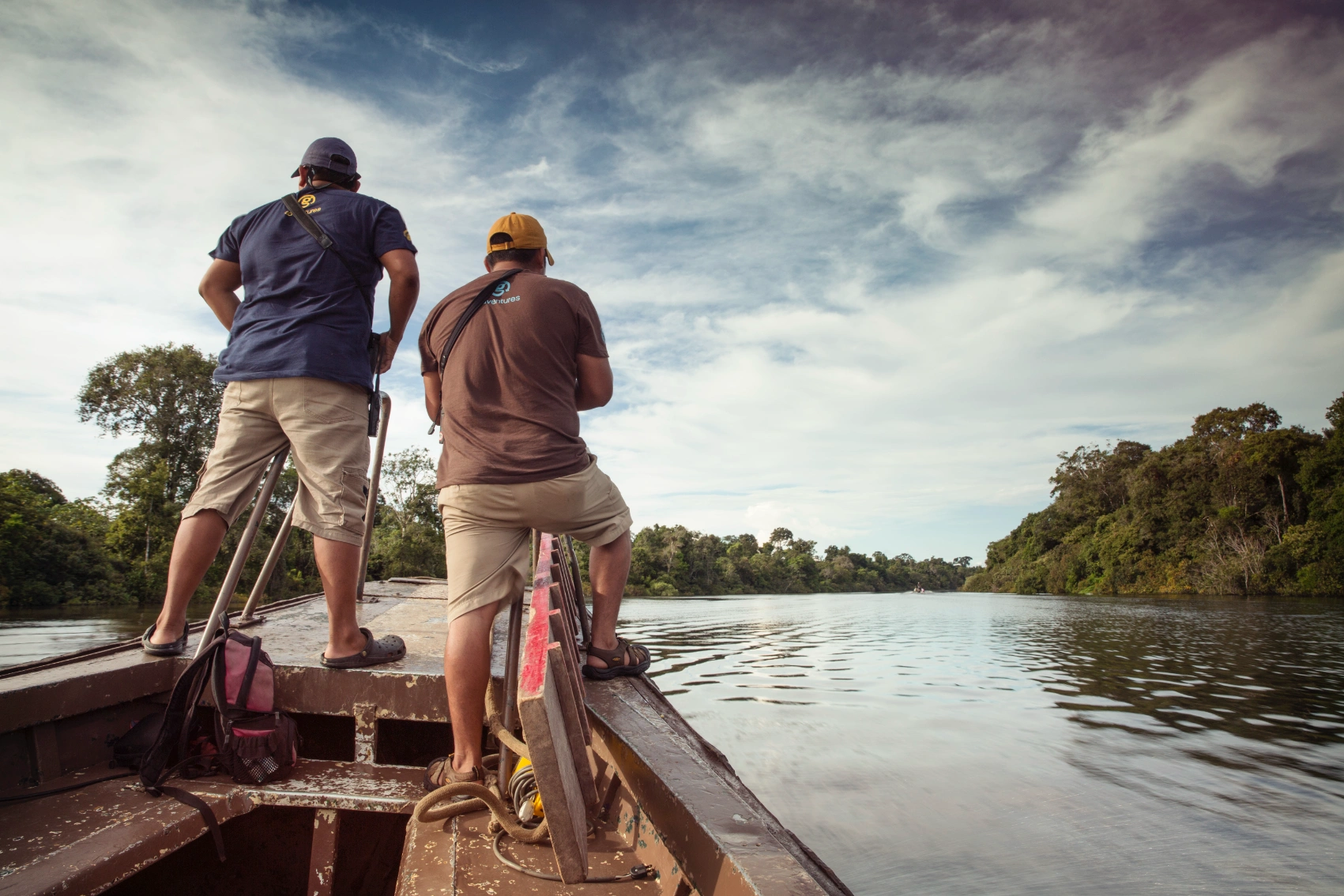 Amazon River, Ecuador Two men drive a motorized canoe along the Amazon in Ecuador