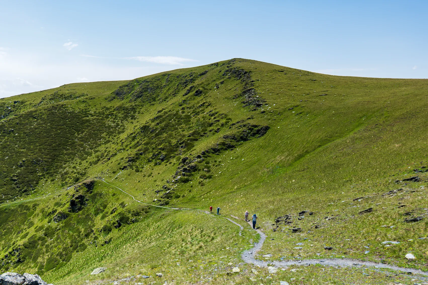 Tusheti, Georgia Hikers in a green valley in summer in Tusheti, Georgia