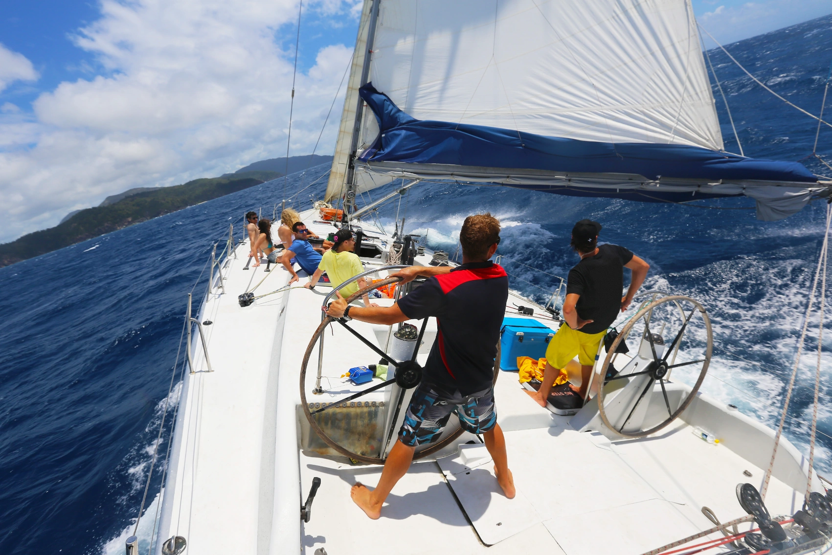 A group of travellers on a sailboat in the Whitsunday Islands in Australia