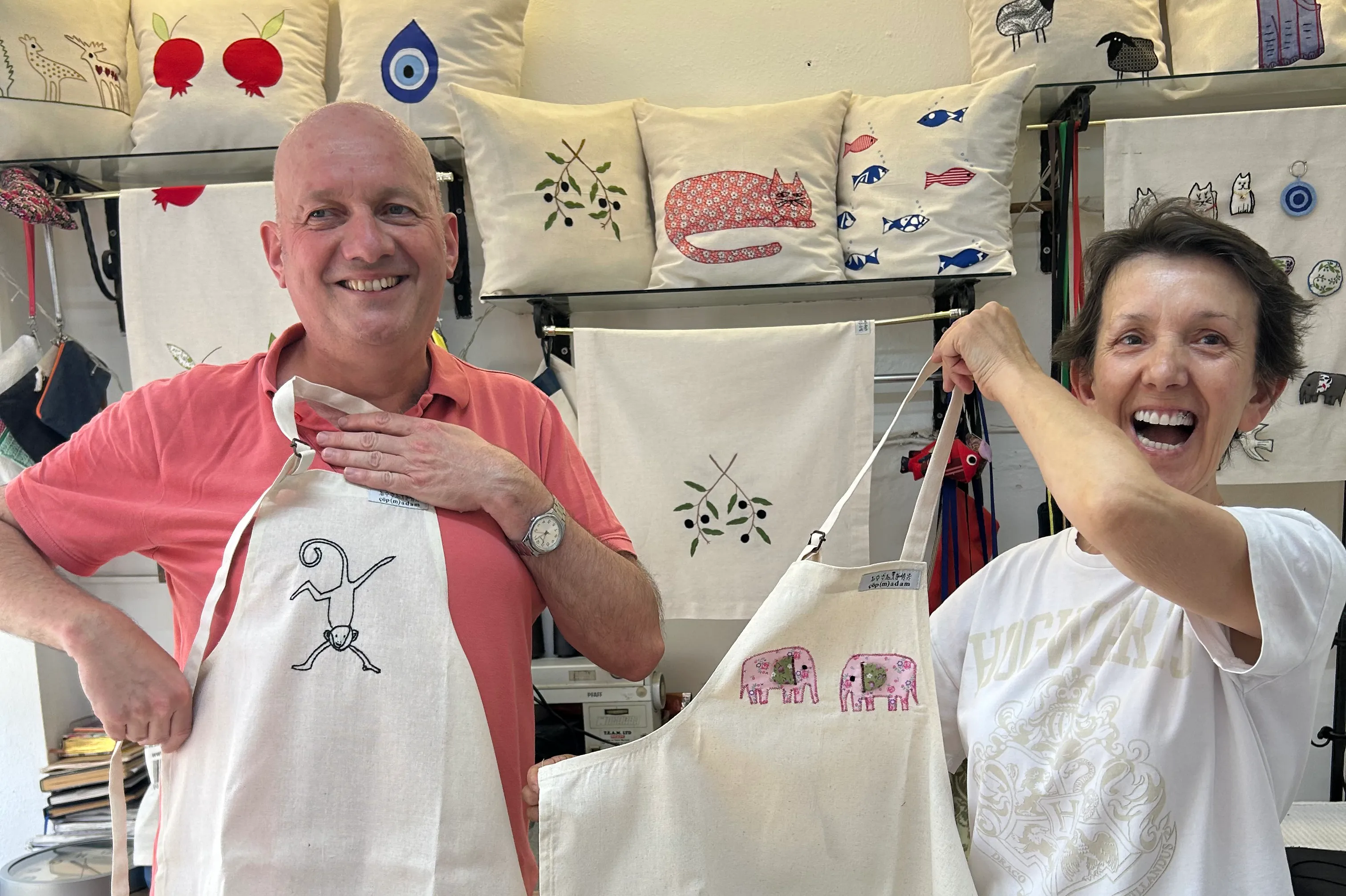 Cöp(m)adam, Turkey Two travellers hold up aprons embroidered by Cöp(m)adam in Turkey