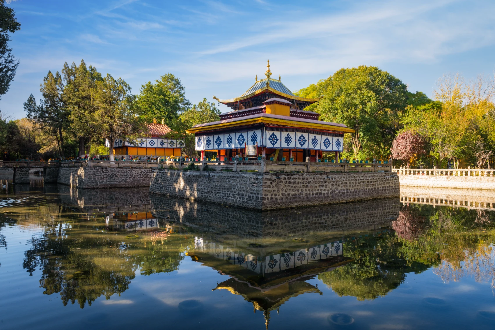 Norbulingka Summer Palace surrounded by water on a sunny day in Lhasa, Tibet