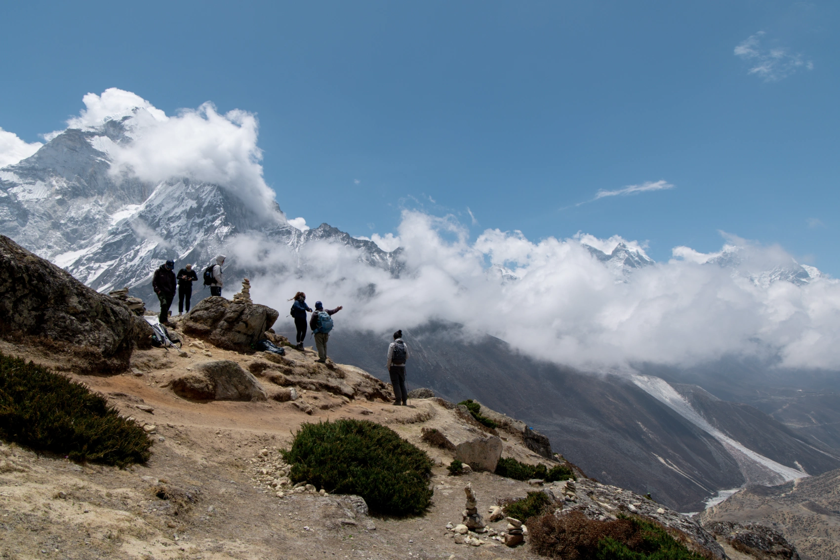 A group of hikers pauses to look at the mountainscape in Nepal