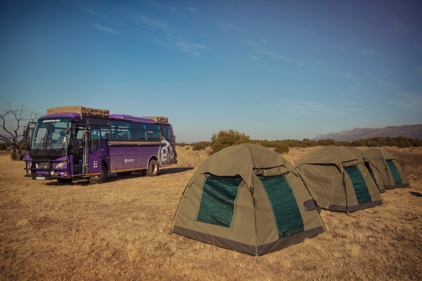 Tents are set up around the G Adventures Lando in Africa