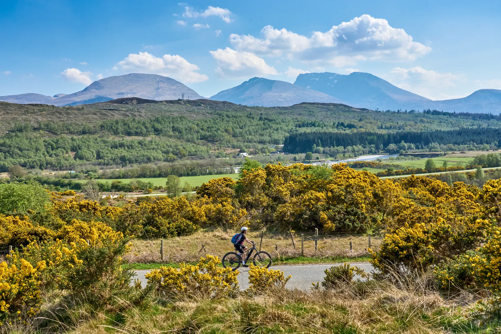 Ben Nevis, Scotland A cyclist rides past the mountain of Ben Nevis in Scotland