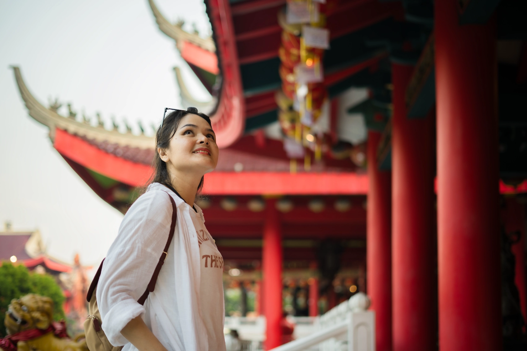 Solo travel planning tips A woman traveller walks around a temple in Indonesia