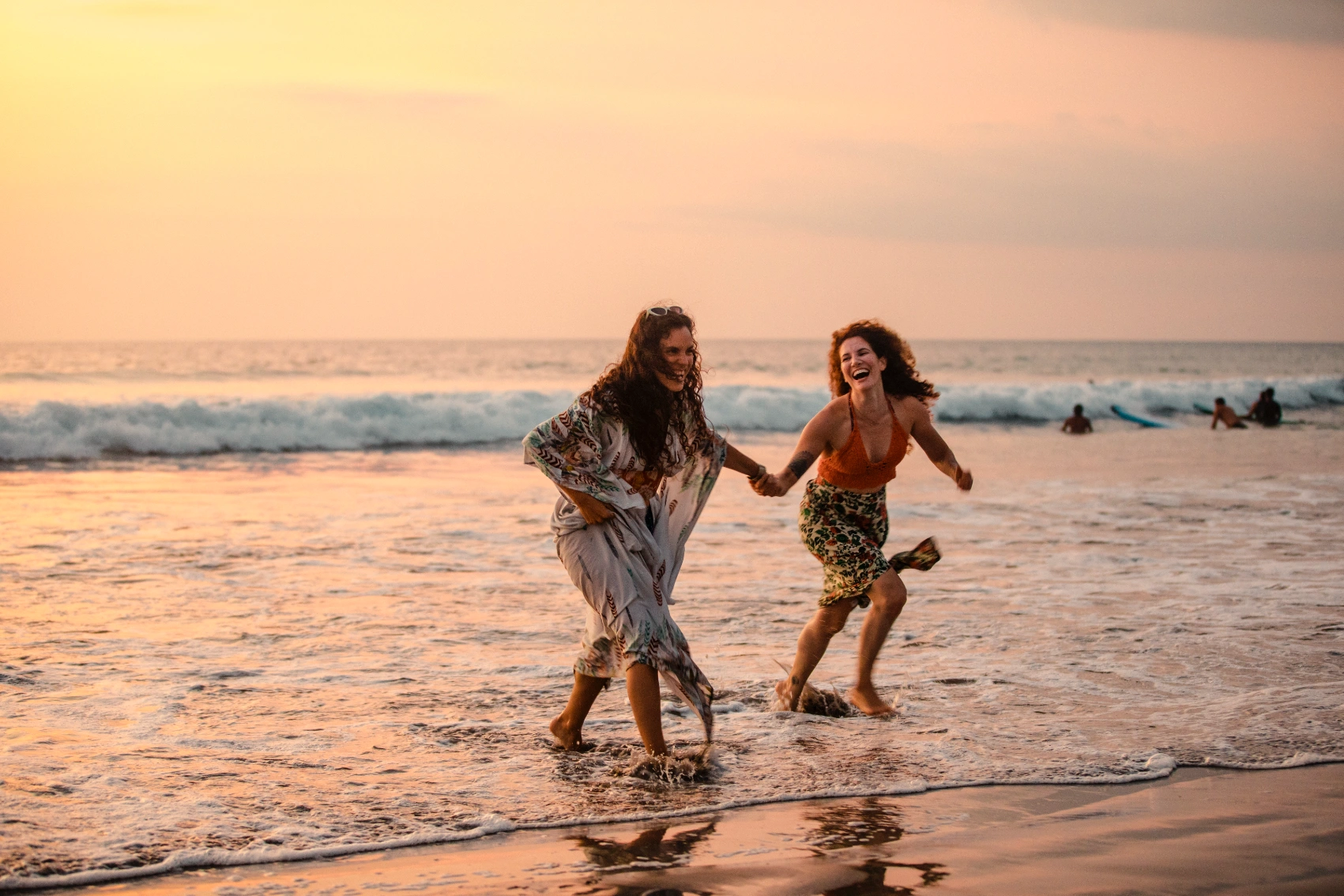 Indonesia welcomes solo travel Two women travellers run into the ocean in Bali, Indonesia