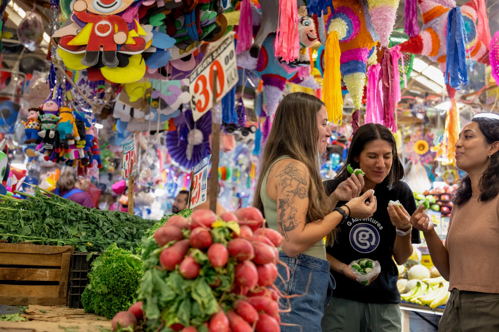 Solo travel in Mexico City A group of travellers samples food at a market in Mexico City