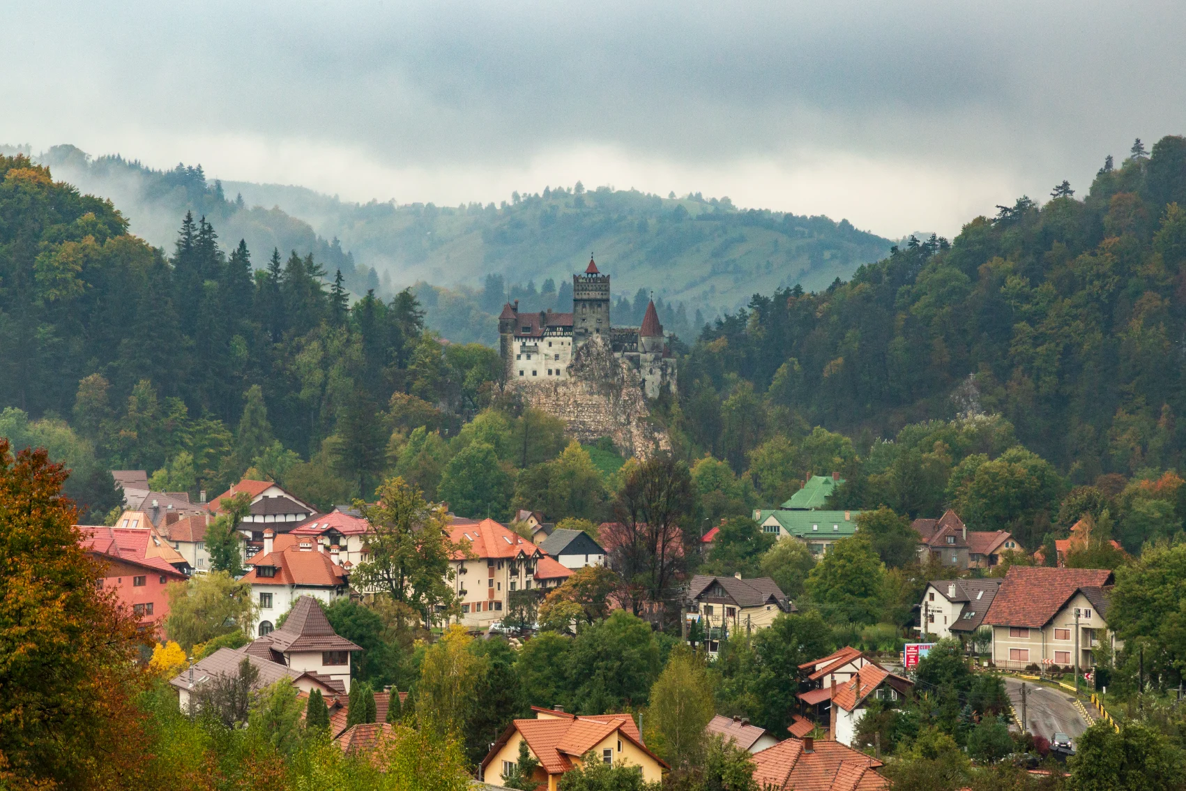 Bran Castle in Transylvania, Romania, surrounded by mountains and forest