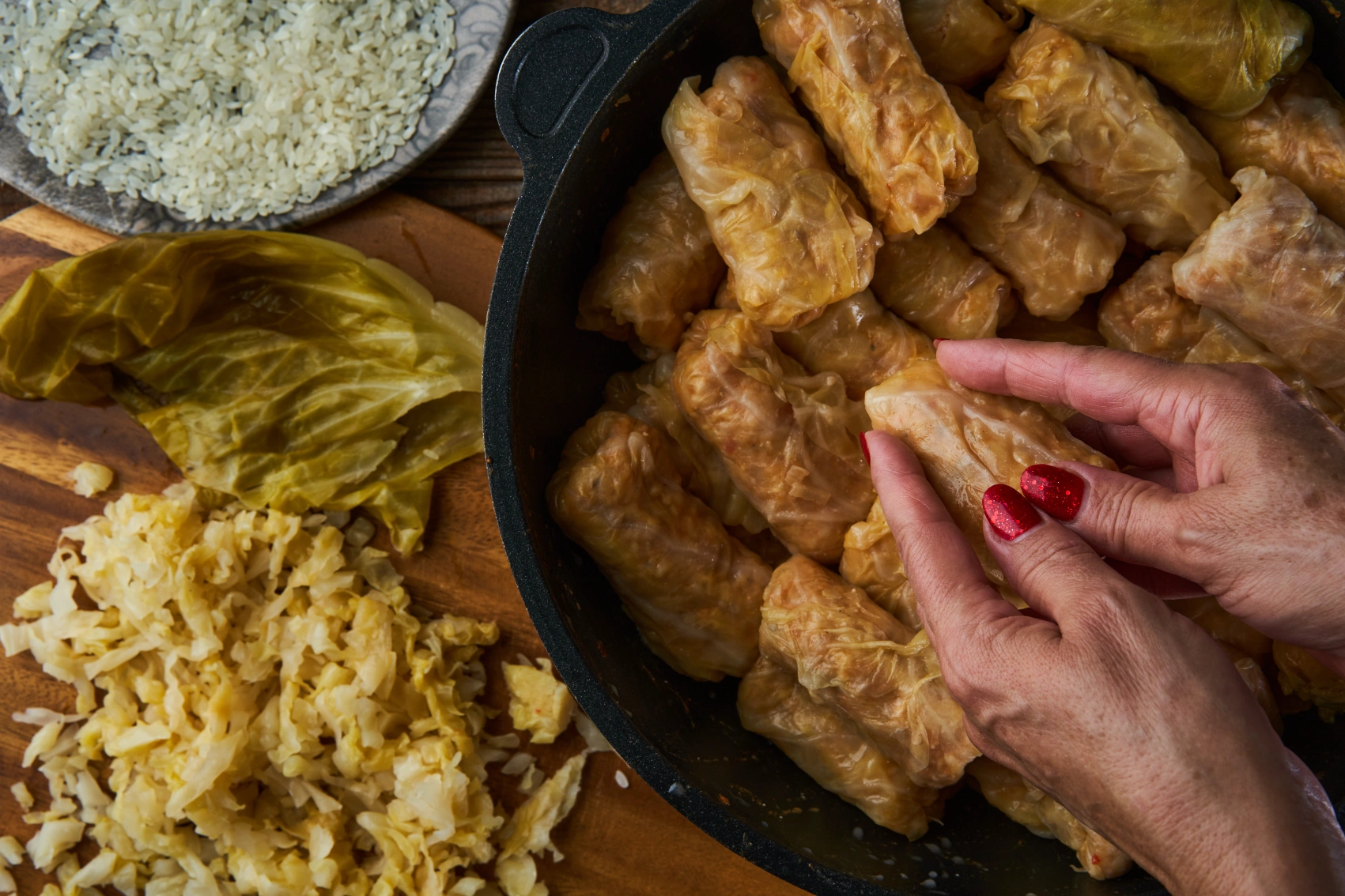 A pair of hands holds sarmale cabbage rolls in Romania