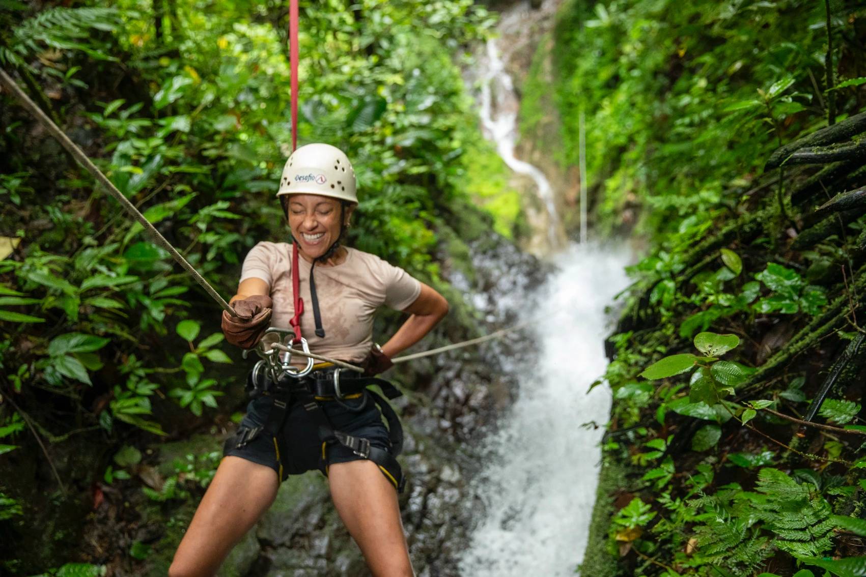 A woman is attached to a zip line in Costa Rica