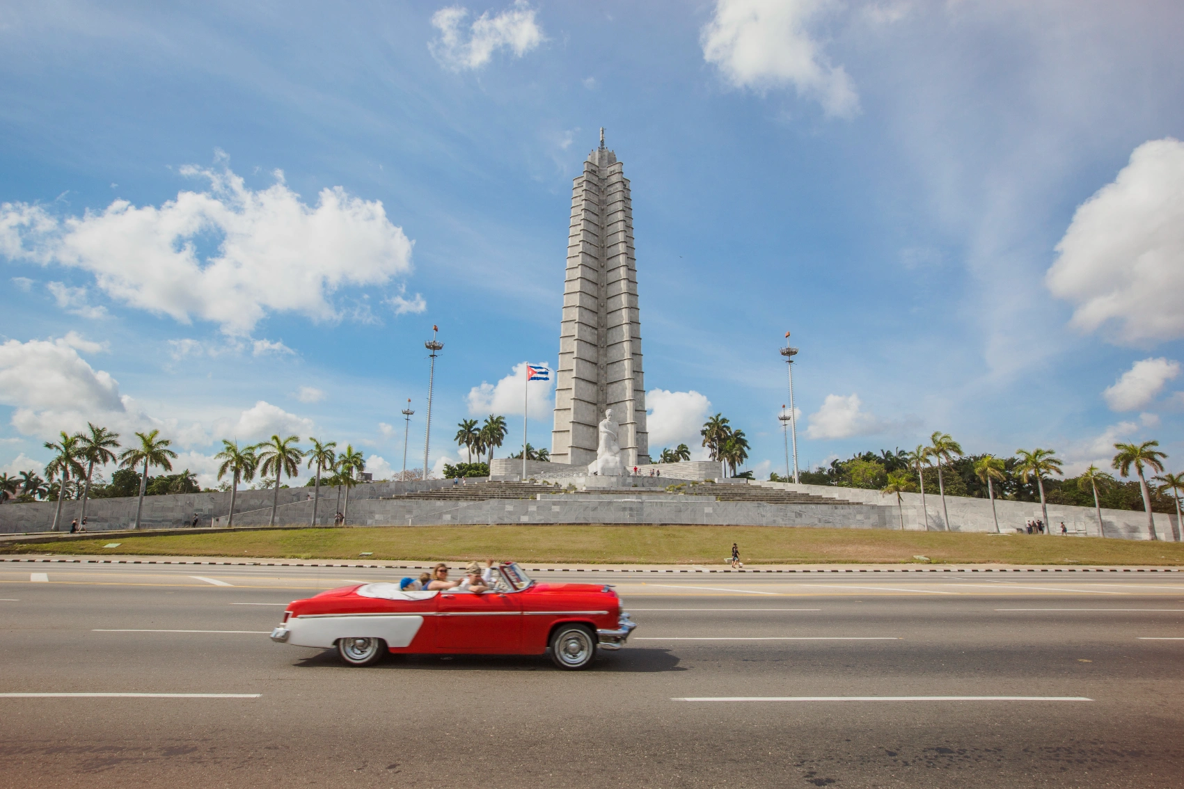 A classic car drives by Revolution Square in Havana, Cuba