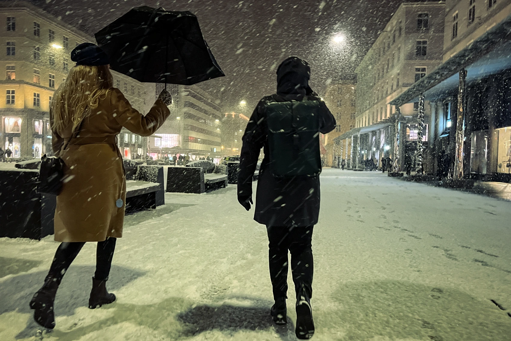 Two people walk through the snow in Bergen, Norway