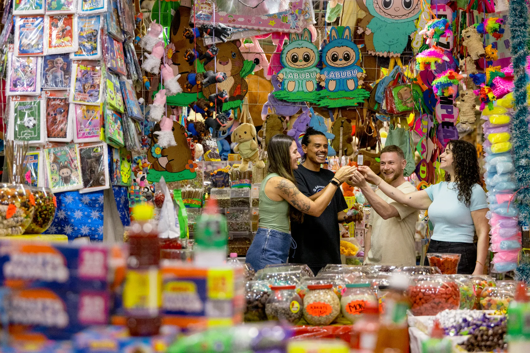 A group of travellers cheers at a food market in Mexico
