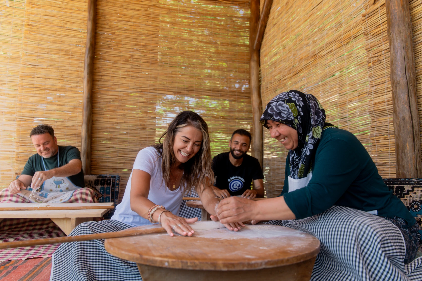 A traveller makes bread with a Turkish woman on a G Adventures trip