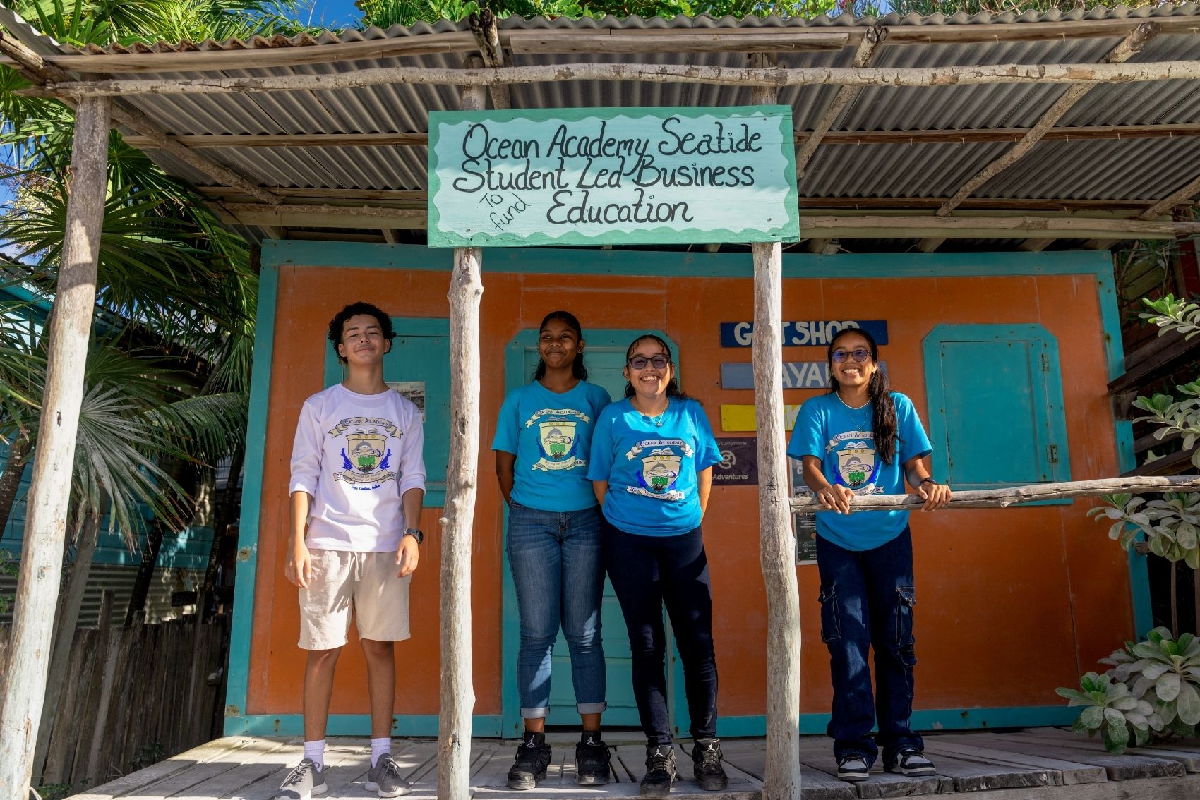A group of kids with their teacher at the Ocean Academy in Caye Caulker, Belize