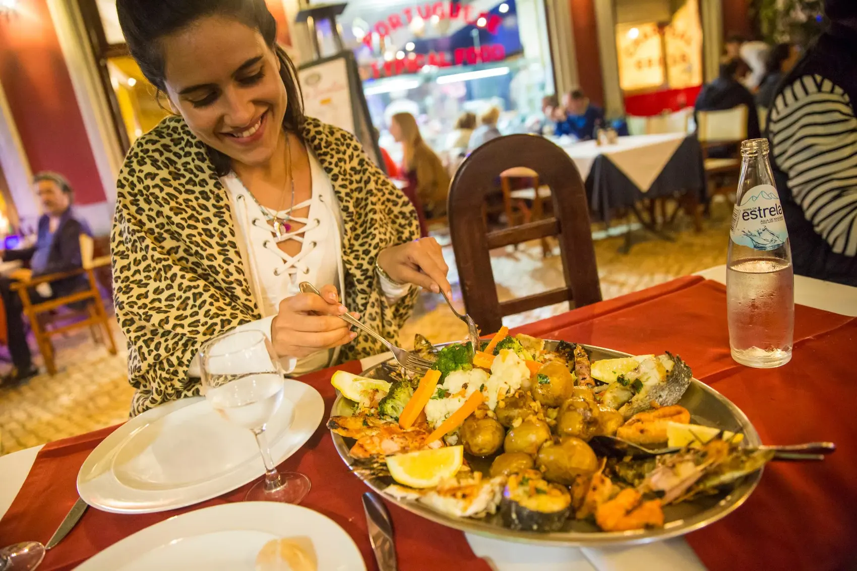 Woman eating food in Lisbon, Portugal