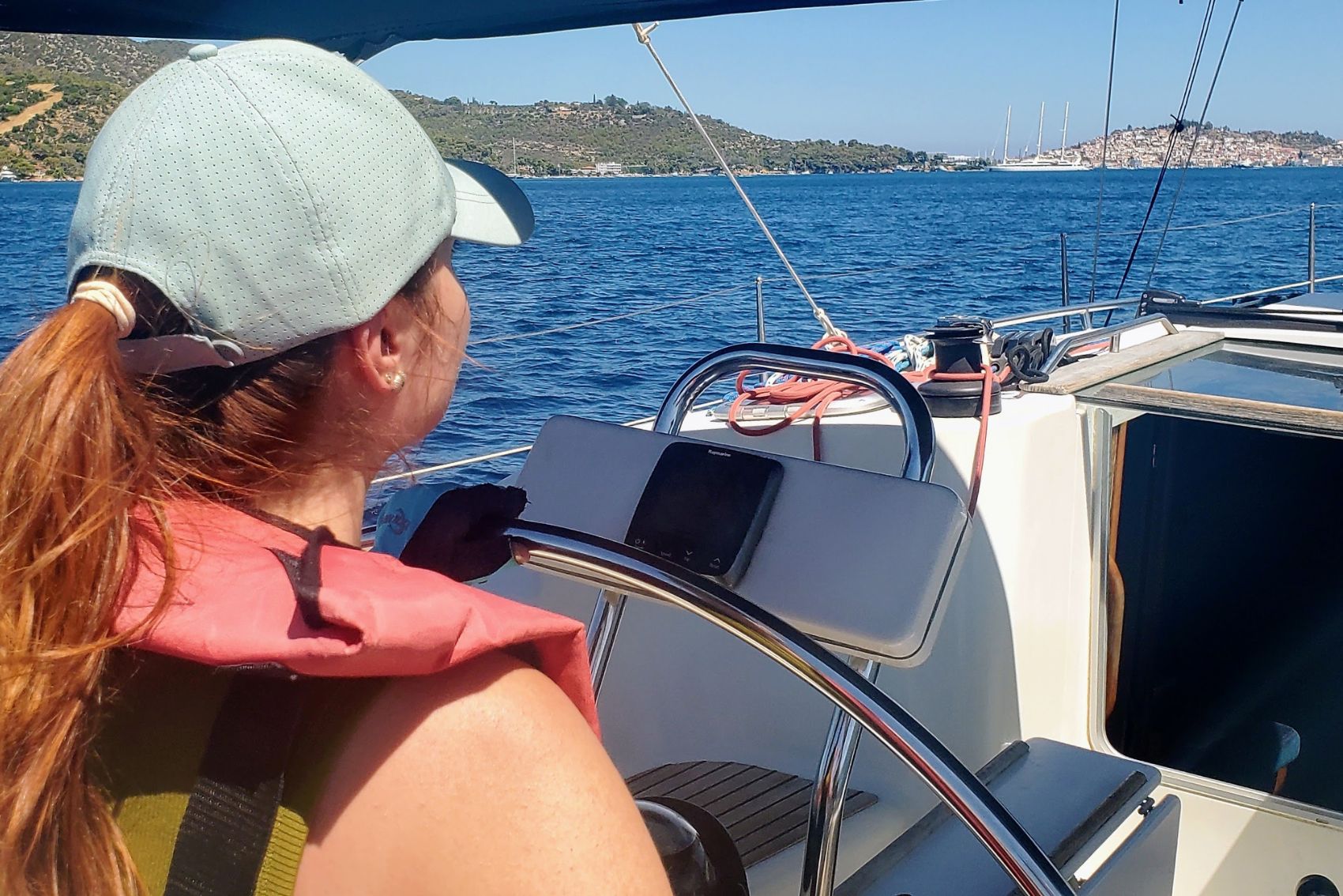 A woman sailing a boat in Poros, Greece