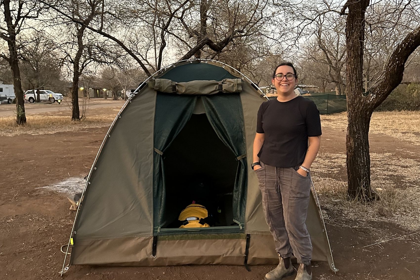 Ana standing outside her tent in Southern Africa