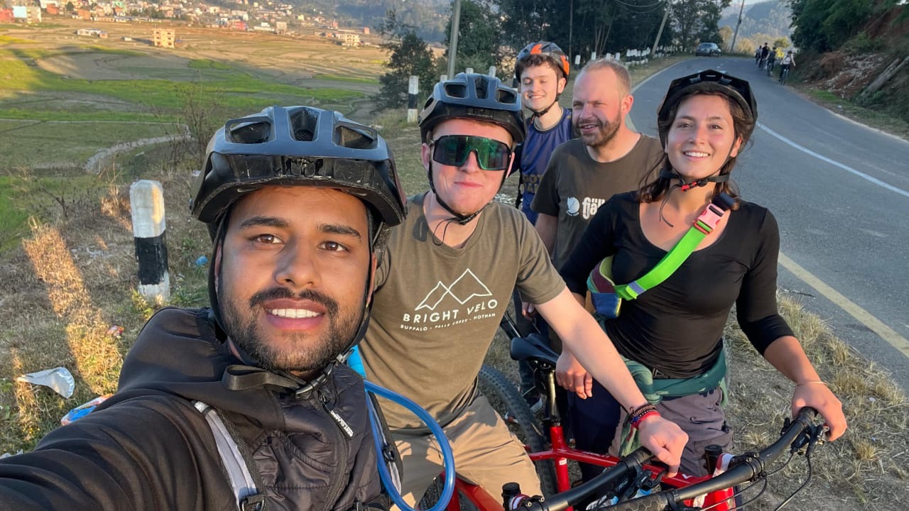 Ashish and travellers posing for a photograph on bikes in Nepal