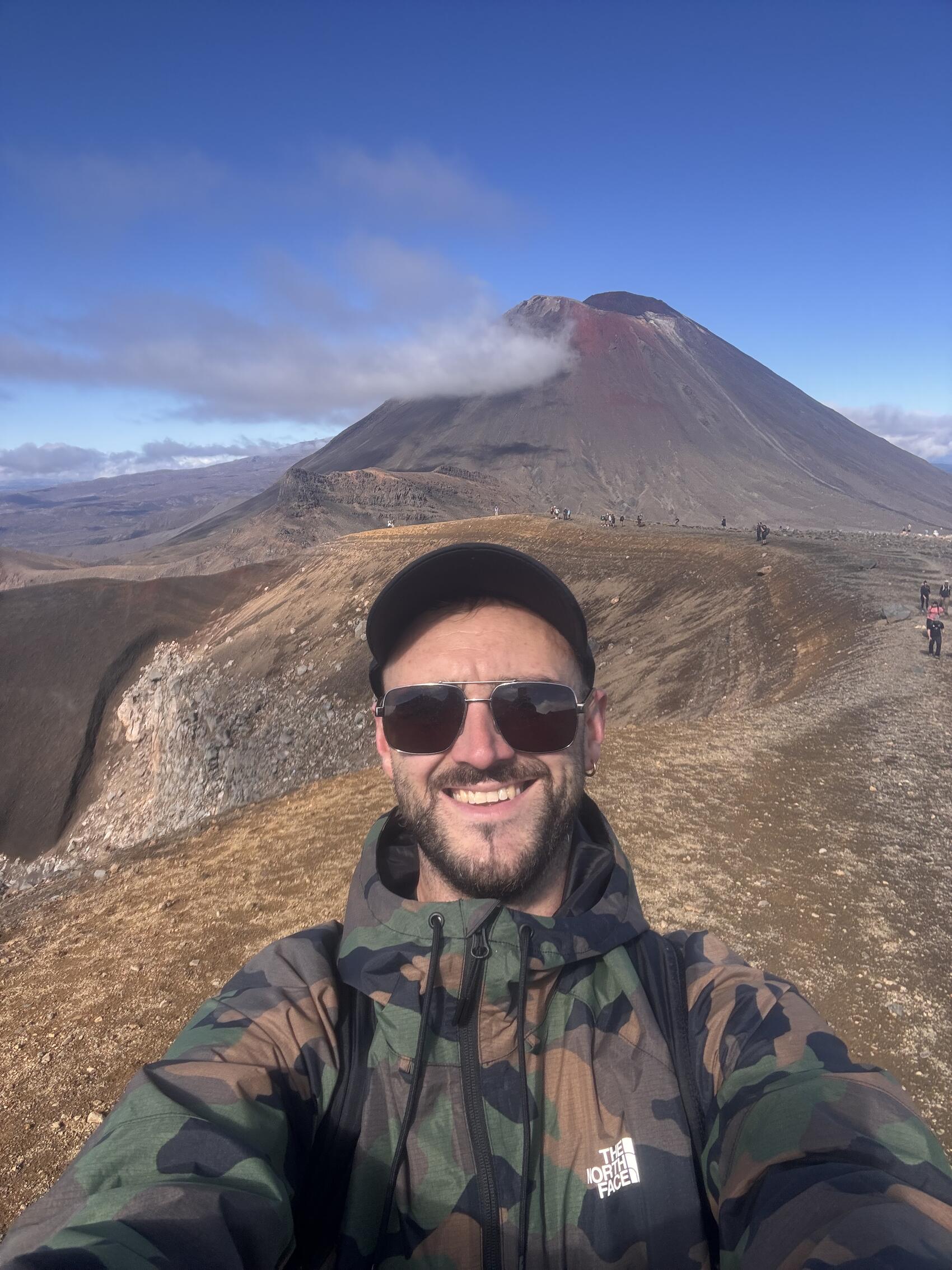 CEO Tom Leonard wearing activewear in front of a volcano in New Zealand&rsquo;s North Island