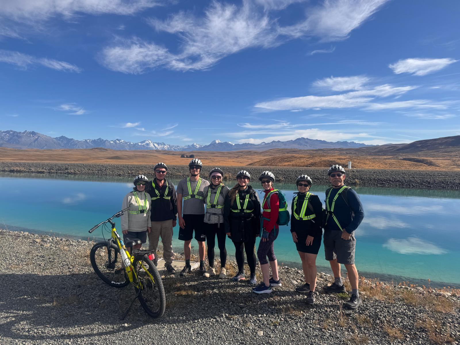 A group of travellers cycling in front of mountains in New Zealand&rsquo;s North Island