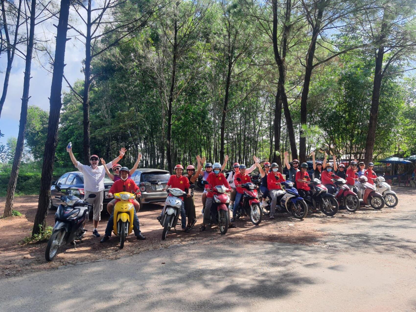 Canadian nurse Marci Holden posing with a group of travellers on bikes on a G Adventures tour