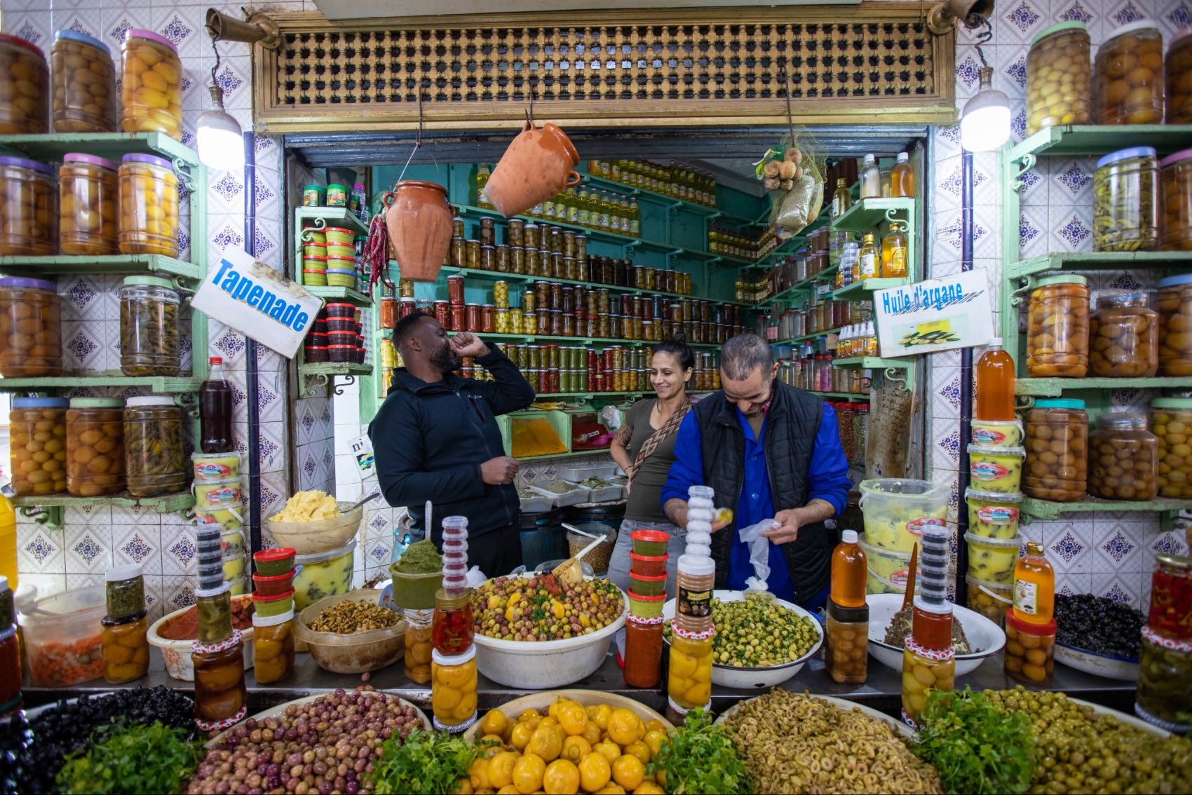 Moroccan market with people chatting in Marrakech