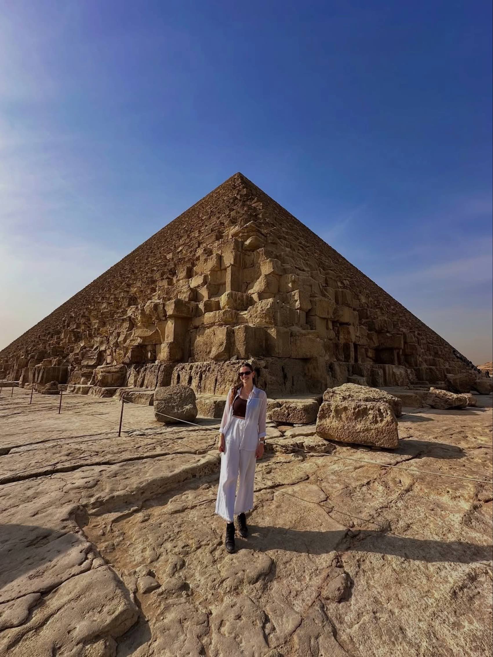 Swiss traveller Michelle Meyer standing in front of a pyramid in Egypt
