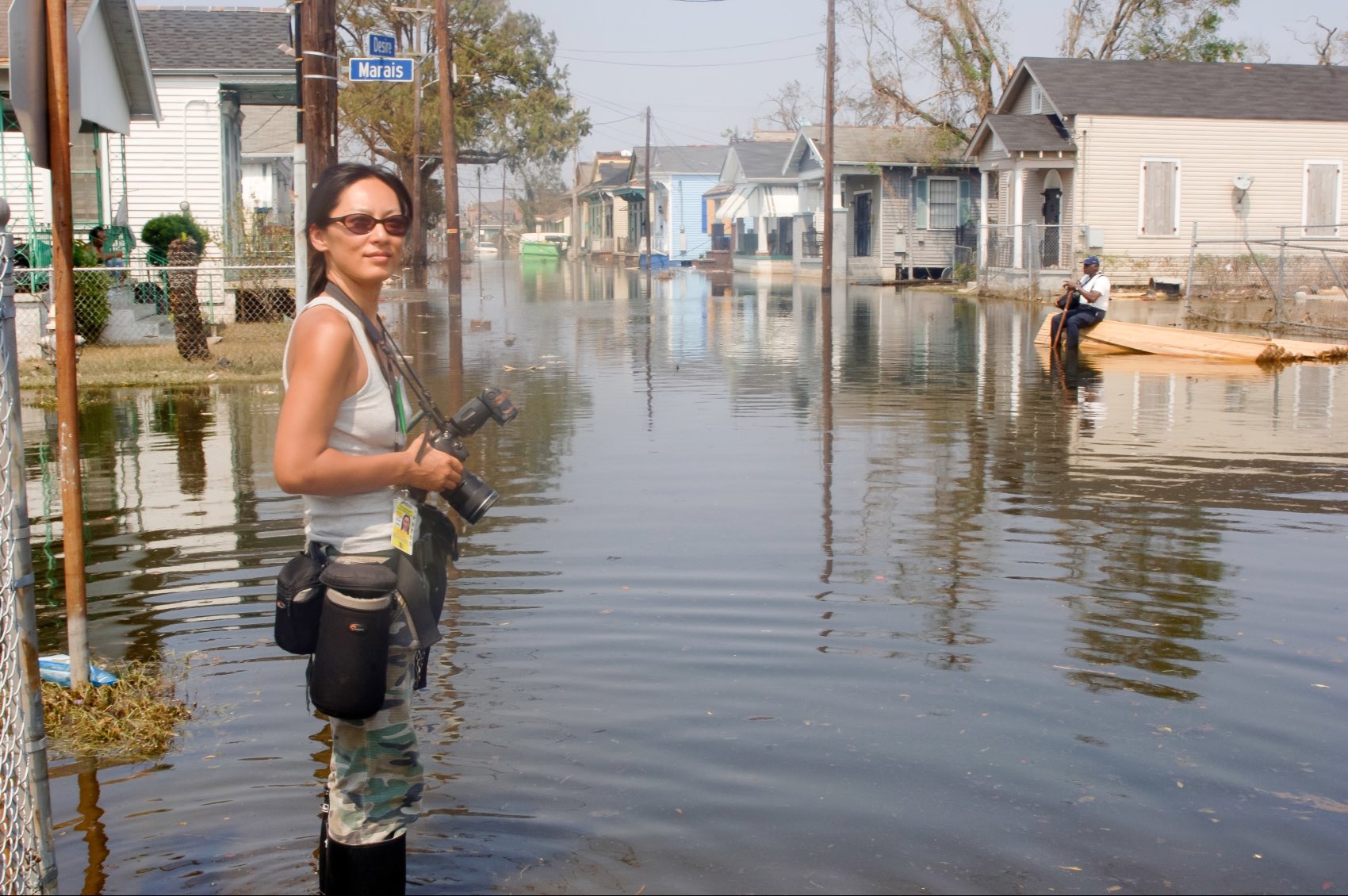 Emmy-nominated photojournalist and filmmaker Shiho Fukada posing for a photograph with her camera near a river