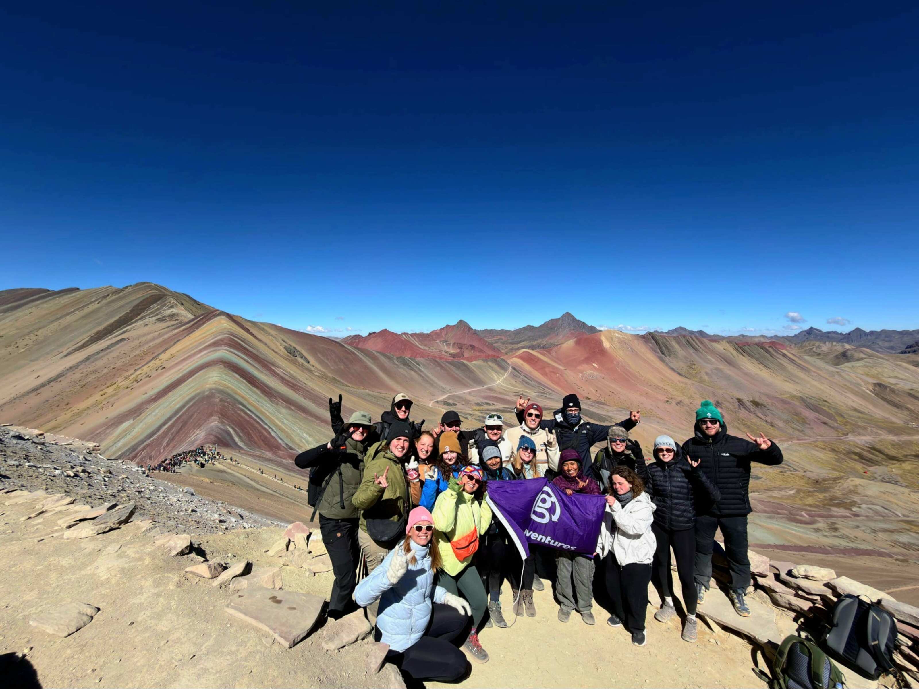 Traveller Milly from New Zealand with her group of fellow travellers posing for a picture at Rainbow Mountain