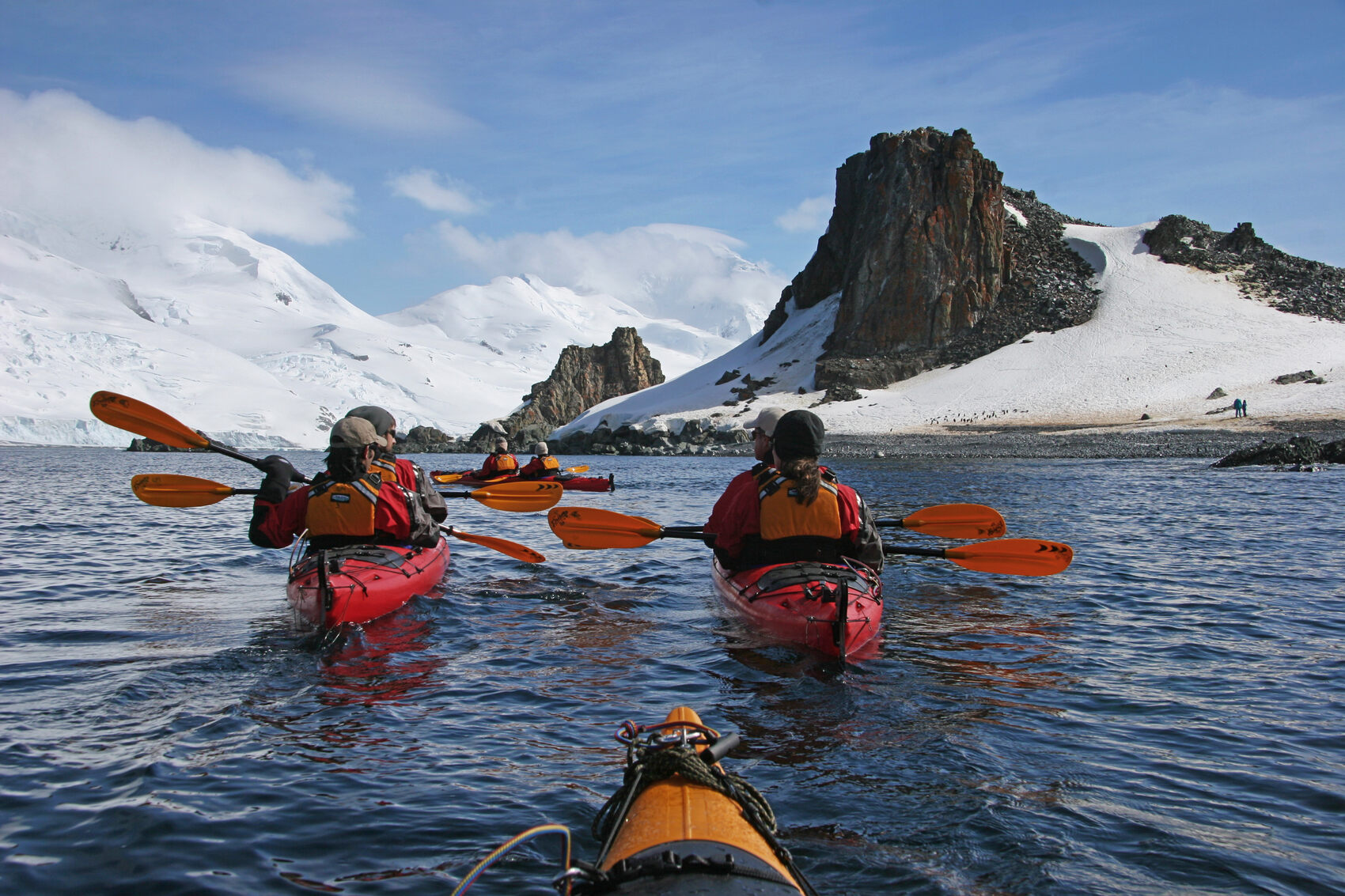 People kayaking in a group in the waters off Antarctica
