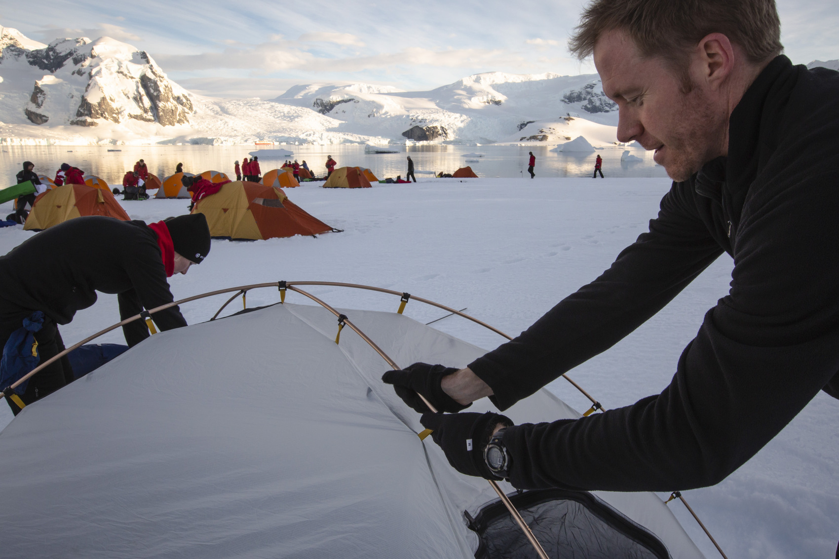 A person putting a tent up on Ronge Island in Antarctica