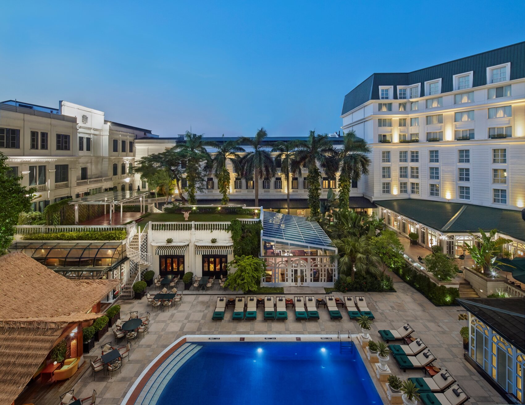 The exterior of the Sofitel Legend Metropole in Hanoi, Vietnam with its swimming pool