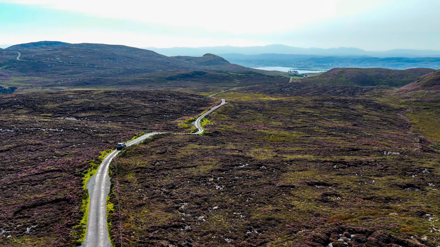 A beautiful stretch of road covered by heather on the Wild Atlantic Road &mdash; Guven Ozdemir