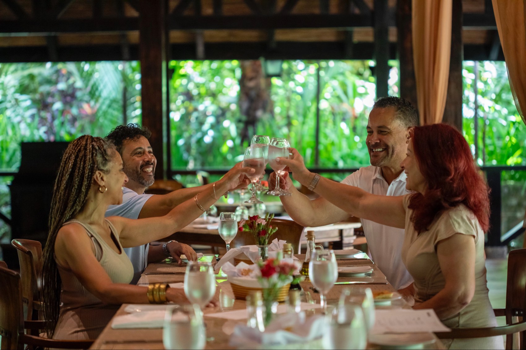 People cheersing at a restaurant in Costa Rica on a Geluxe tour — Shereen Mroueh