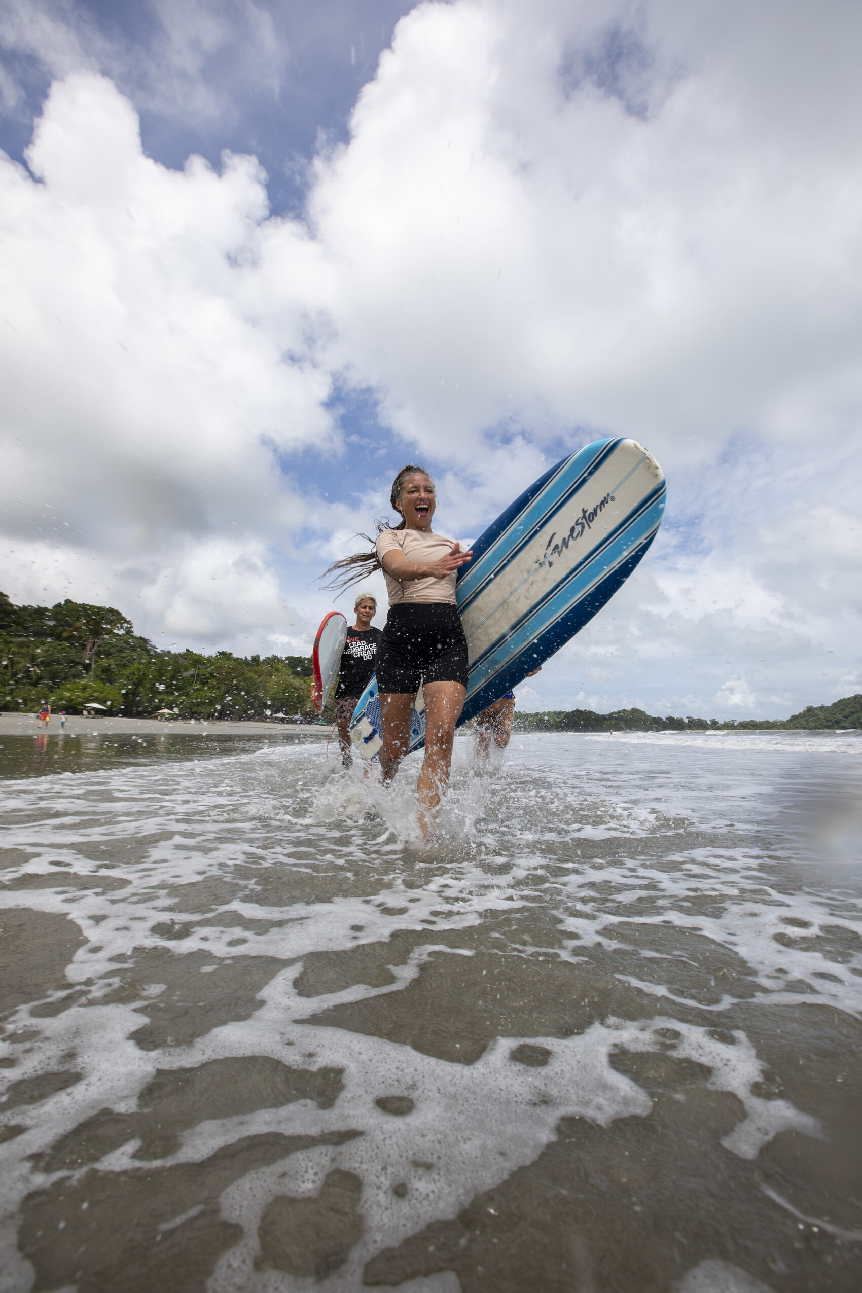 A woman about to go surfing on Manuel Antonio Beach in Costa Rica — Shereen Mroueh