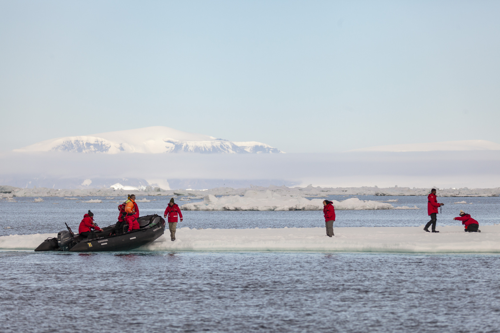 People walking onto the ice flow in Antarctica
